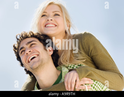 Man giving girlfriend piggyback ride Stock Photo