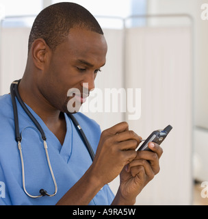 Male doctor using electronic organizer Stock Photo
