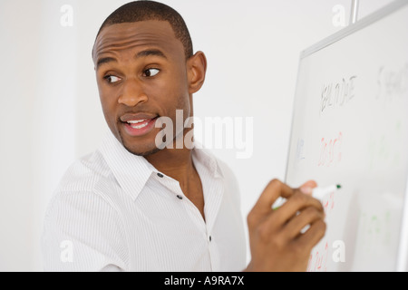 Businessman writing on whiteboard Stock Photo