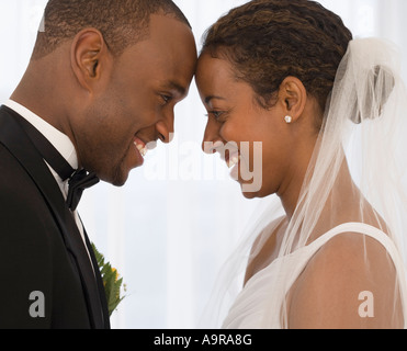 Bride and groom smiling at each other Stock Photo
