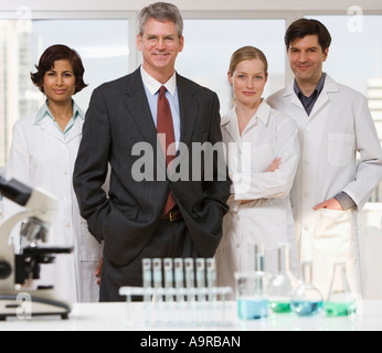 Businessman and scientists in laboratory Stock Photo