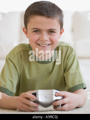 Boy holding video game controller Stock Photo