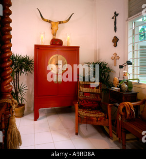 Bedroom in Fiebrich House A red lacquer weddig cabinet contrast with the white walls and white tiled floor Stock Photo