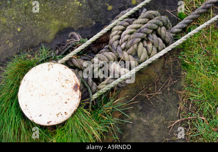 A composition using a mooring post and ropes taken at a dockside Stock Photo