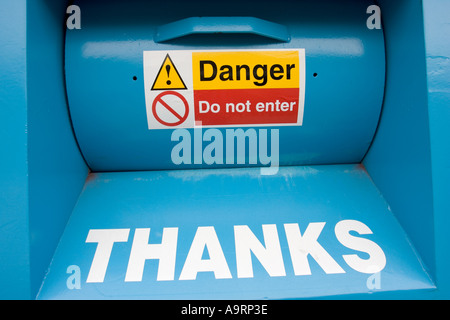 Danger do not enter sign in yellow and red on blue recycling box Cheltenham Stock Photo