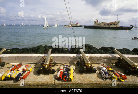 Cannons in front of  Royal Yacht Club building are fired to start race during Cowes Week. The Solent Red Funnel Ferry  Isle of Wight. 1980s UK Stock Photo