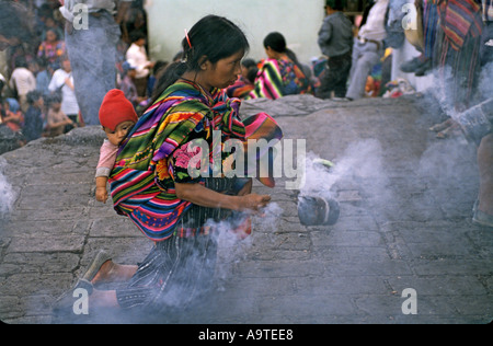 Maya woman with baby worships on steps of Santo Tomas Catholic church Chichicastenango Guatemala Stock Photo