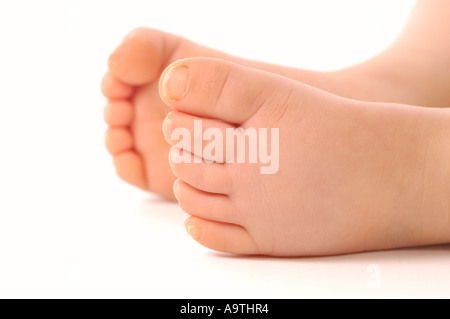 Close-up of a caucasian baby's feet on a white background. Stock Photo