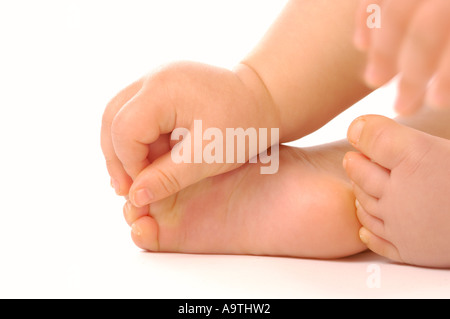 close-up of a caucasian baby's hand holding its foot. Stock Photo