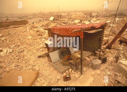 Iraq Iraqi Marsh Arabs soldier 1984. A soldier shelter from the sun  in a  village destroyed by fighting. HOMER SYKES Stock Photo