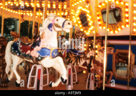 Carousel horse on merry go round in amusement park Stock Photo