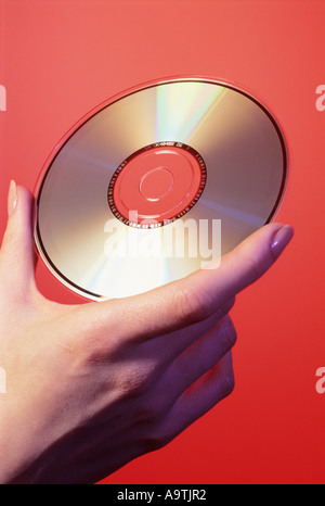 WOMAN'S HAND HOLDING CD ROM Stock Photo
