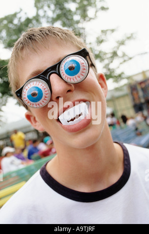 FACE OF BOY WITH GOGGLE EYES & FAKE TEETH Stock Photo