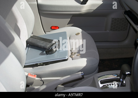 Valuables left on display on car seat Stock Photo