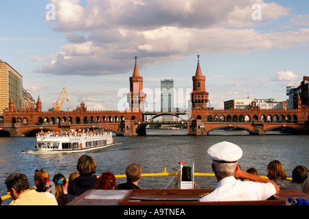 Berlin river spree tourist boat captain Oberbaum bridge Stock Photo