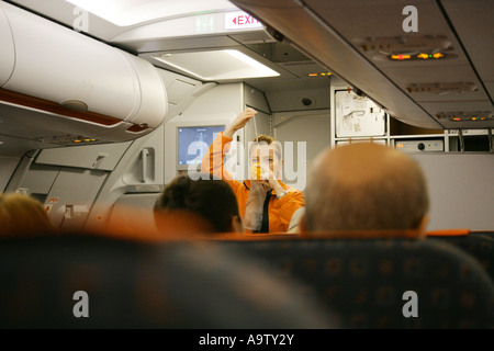 Flight attendant showing emergency procedures to air passengers, England, UK EDITORIAL USE ONLY Stock Photo