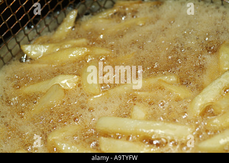 Chips in a Deep Fat Fryer Cooking Stock Photo