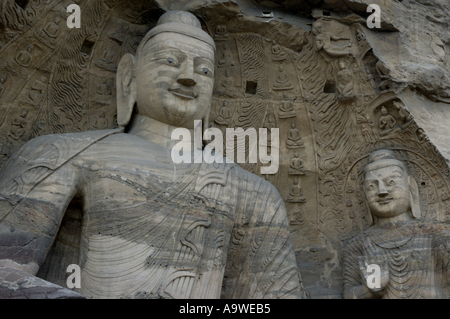 Giant Buddha statues carved inside a grotto, Yungang Grottoes, Shanxi, China. Stock Photo