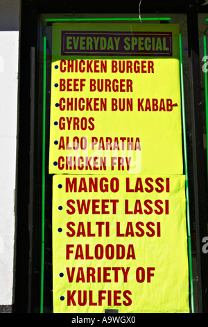 STREET SCENE Chicago Illinois Sign in store window for various foods along Devon Avenue multiethnic shopping district Stock Photo