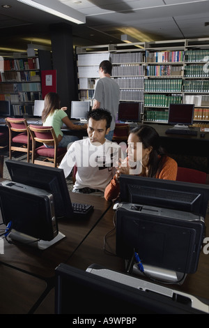 College students using computers in the library Stock Photo