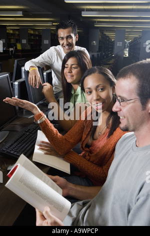 Young students using computers in the library Stock Photo