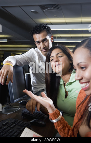 Young students using computers in the library Stock Photo