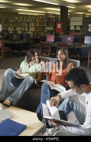 Students in library sitting on sofas studying Stock Photo