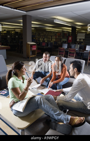 Students in library sitting on sofas studying Stock Photo