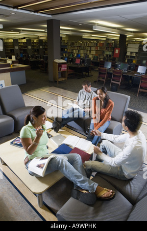 Students in library sitting on sofas studying Stock Photo