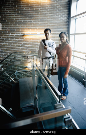 University students standing on stairway between classes Stock Photo