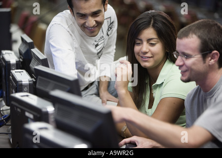 Three university students using computer Stock Photo