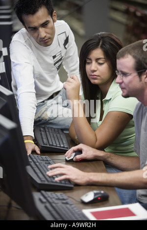 Three university students using computer Stock Photo