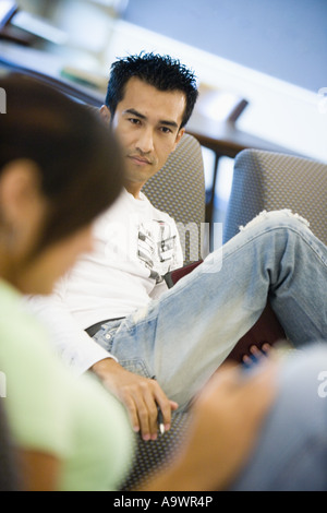 Portrait of a young man sitting on the sofa Stock Photo