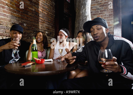 Young men and women in hip-hop fashion partying at a bar Stock Photo