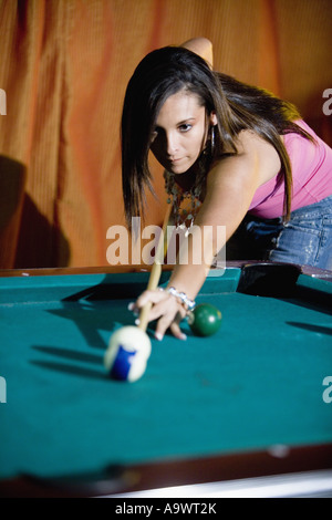 Young woman shooting pool Stock Photo