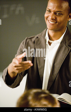 Teacher gesturing to students in the classroom Stock Photo