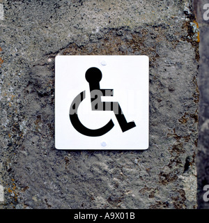 Disabled access sign on stone wall in North Wales, UK Stock Photo