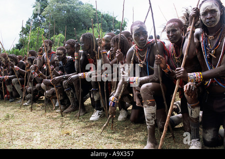 Lolgorian, Kenya. Siria Maasai; Eunoto ceremony; line of kneeling moran with white ochre body paint. Stock Photo