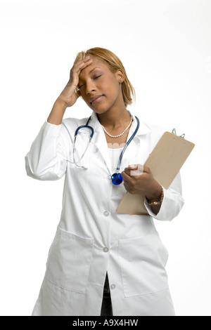 Female doctor overcome with some thought or feeling or perhaps she is just exhausted Stock Photo