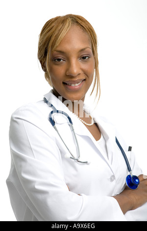 Attractive young female doctor smiling at the camera wearing a white coat and stethoscope Stock Photo