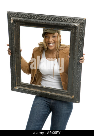 Happy young African American woman in fashionable clothes is moving furniture Stock Photo