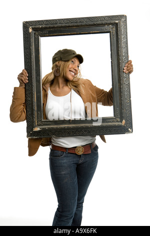 Attractive young black woman messing around and posing with a picture frame Stock Photo