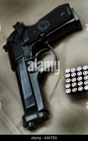 a beretta pistol gun with a box of 9mm bullets ammunition handgun Stock Photo