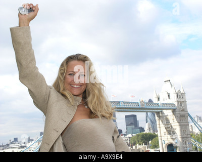 attractive business woman thirties in City of London punching the air in delight Stock Photo