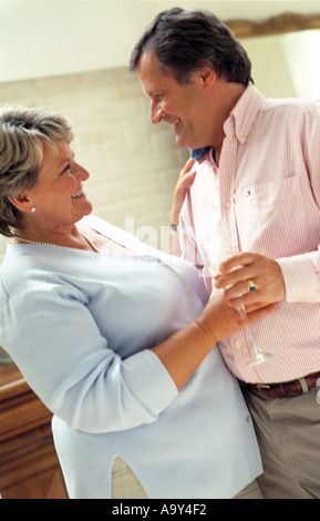 middle aged couple dancing in kitchen Stock Photo