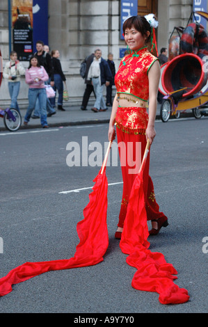 Japanese dancer performing an 'air drawing' with red silks at the big draw opening event, London, UK Stock Photo