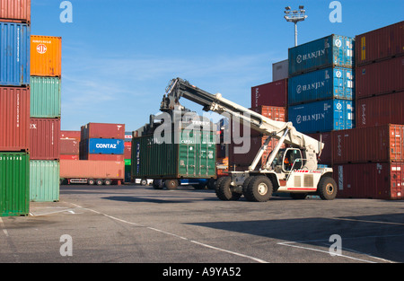 lifter loader moving freight container in container terminal Stock Photo