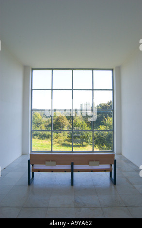 wooden bench in empty room facing large window in Insel Hombroich Art Museum Stock Photo
