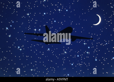 SILHOUETTE OF AIRBORNE BOEING 767 COMMERCIAL PASSENGER AIRCRAFT AND STARRY NIGHT SKY Stock Photo