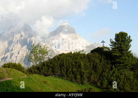 Viewpoint with cross to mountains Hoher Gaif (2288 m) and Alpspitze (2628 m) Wettersteingebirge Bavaria Germany Stock Photo